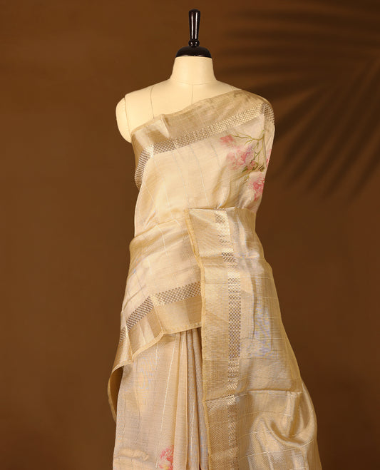 Radiant gold organza Kerala saree adorned with delicate floral accents, a shimmering zari border and a matching blouse