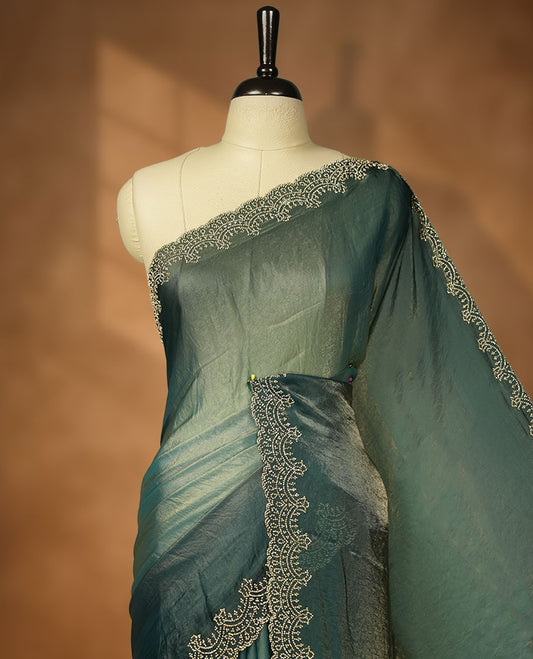 Teal blue with gold  colour shimmer fancy saree adorned body, paired with a with delicate gold stone worked border, with matching blouse