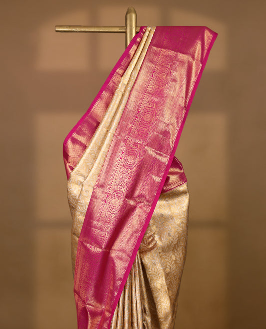 Gold colour tissue brocade saree with gold and silver zari kodi design on body, gold zari traditional magenta border, rich matching pallu with Antique zari motifs, paired with matching blouse.