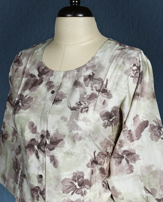 Off white kurti with an all over muted brown floral print, styled with a round neckline, front button down design, and three quarter sleeves