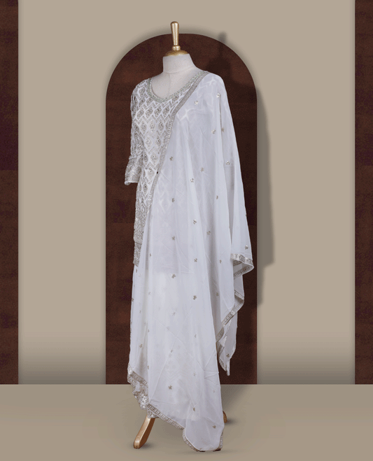 Elegant Off white colour embroidered sharara set featuring intricate copper toned thread work and delicate stones & sequin detailing, paired with a graceful off white dupatta adorned with subtle motifs and a beautifully flared embroidered bottom.