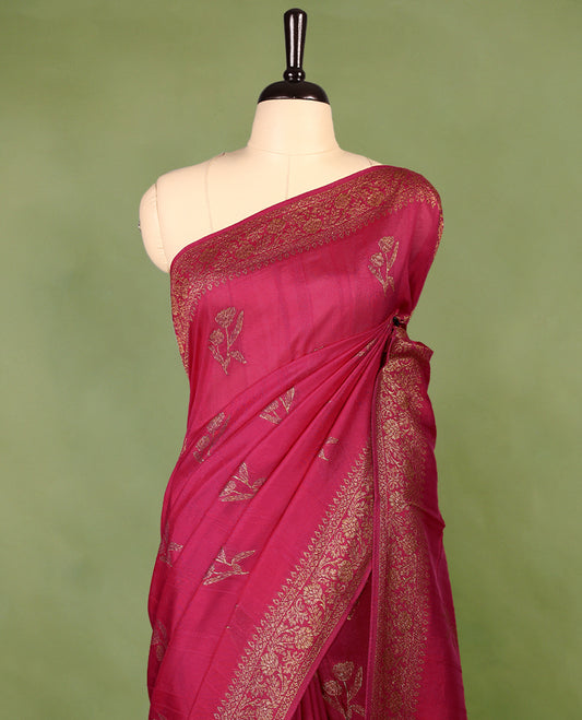 Deep Magenta colour semi Banaras tussar georgette saree embellished with antique zari flower motifs across the body, complemented by a rich Banaras border and paired with a matching blouse.