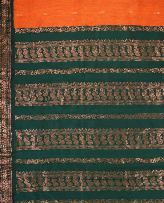 Rust Orange colour mixed Kalyani cotton saree featuring Copper zari motifs throughout the body, paired with Bottle Green colour traditional border and pallu, with matching blouse