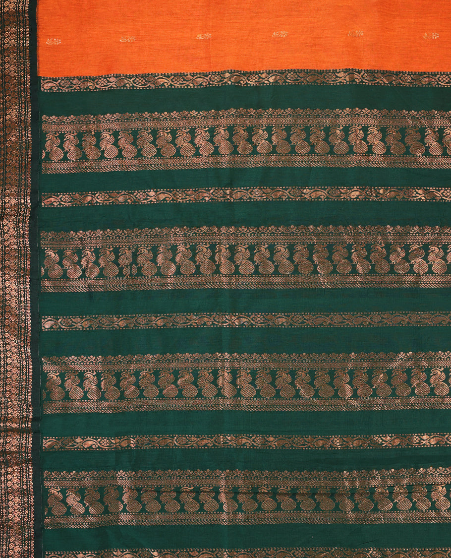 Rust Orange colour mixed Kalyani cotton saree featuring Copper zari motifs throughout the body, paired with Bottle Green colour traditional border and pallu, with matching blouse