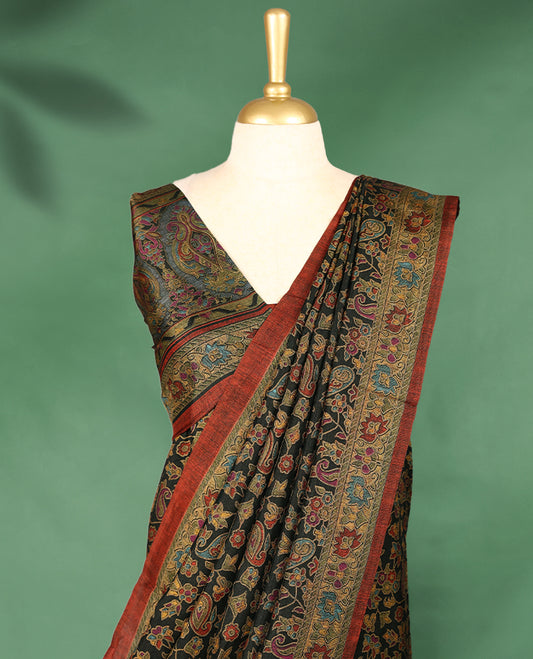 Dark colour Manipuri saree features a body filled with vibrant paisley and floral block motifs, accentuated by a multicolour floral printed border and paired with a matching blouse.