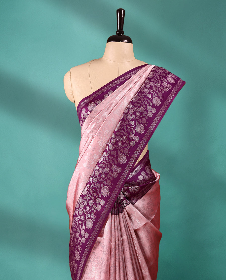 Light Onion coloured semi silk saree featuring a Silver coloured floral jaal design on the body, paired with a Grape coloured border and matching blouse.