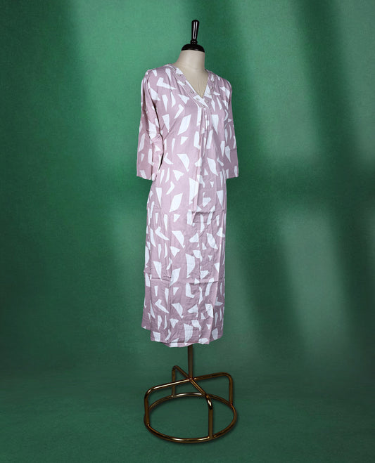 Pastel pink colour kurti featuring white tribalinspired geometric prints, styled with a V neckline adorned with subtle thread embroidery and 3/4th sleeves ideal for a contemporary ethnic look.