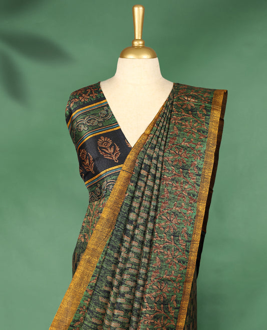 Deep green colour Manipuri saree features a body adorned with intricate Block motifs, complemented by a rich golden yellow Floral Printed border, and comes with a matching blouse.