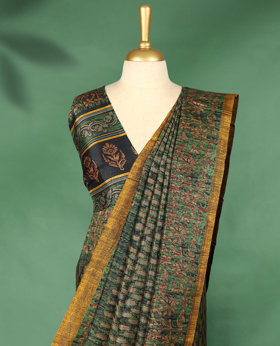 Deep green colour Manipuri saree features a body adorned with intricate Block motifs, complemented by a rich golden yellow Floral Printed border, and comes with a matching blouse.
