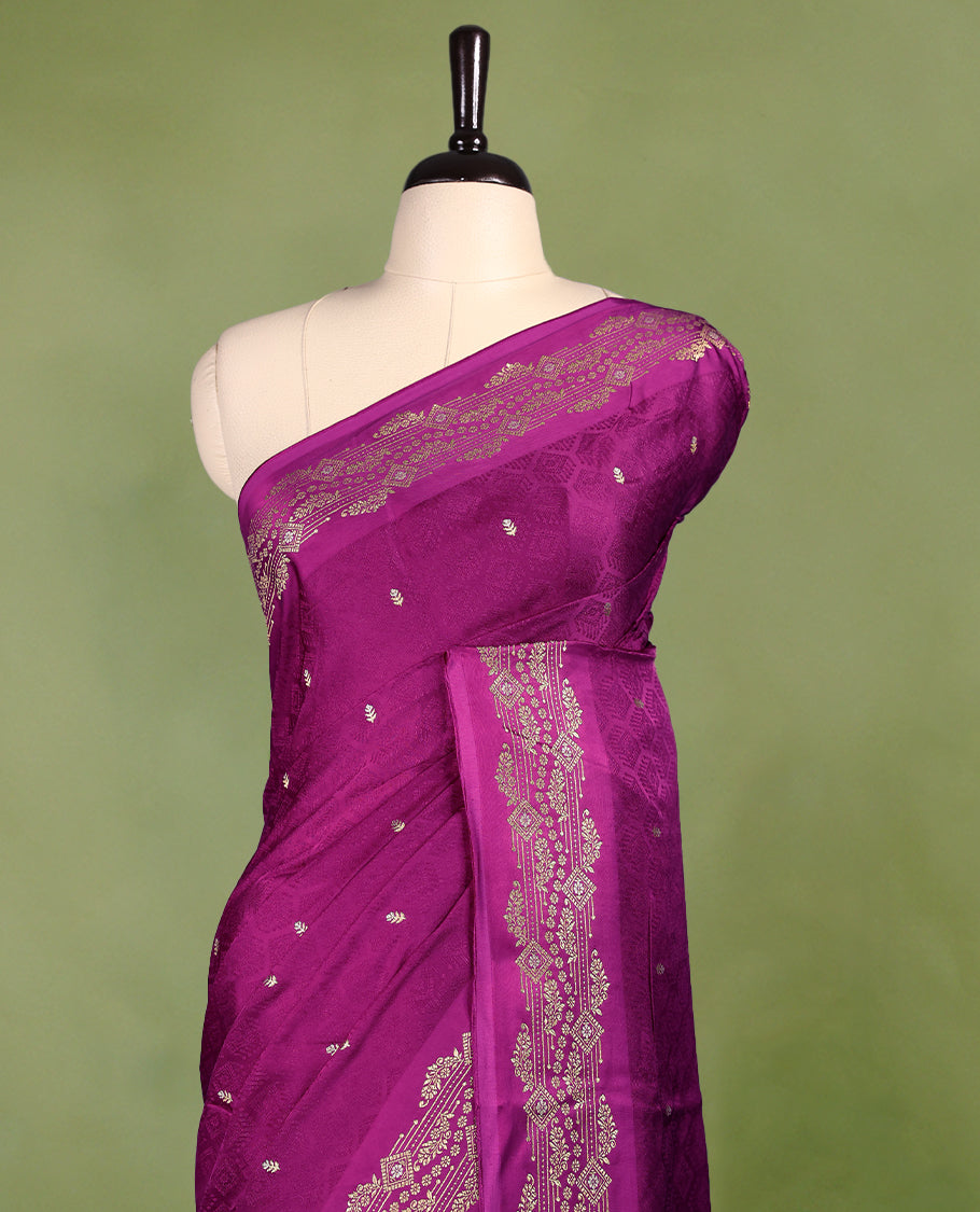 Grape colour pure Banaras crepe saree showcases elegant Gold & Silver zari Motifs all over the body, a traditional gold & Silver zari border, a rich intricately woven pallu, and comes with a matching blouse.