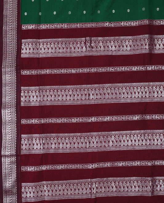 Bottle Green colour mixed Kalyani cotton saree featuring Silver zari flower motifs throughout the body, paired with a Maroon colour traditional border and pallu, with matching blouse