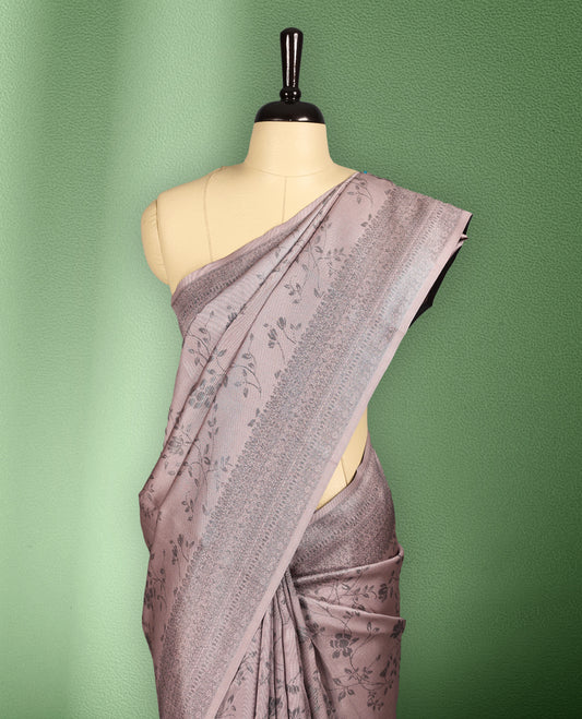 Light Pastel Pink colour semi silk saree featuring neem zari floral kodi motifs all over the body, complemented by a rich self colour woven border, with matching blouse.