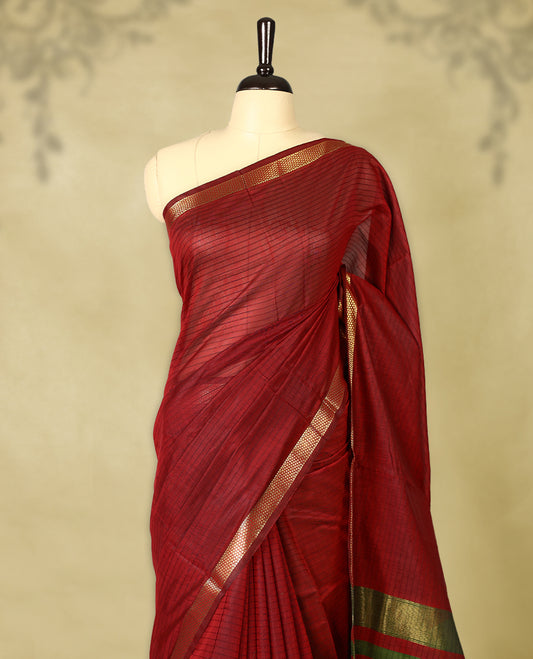 Deep Red colour chanderi cotton saree with fine striped body, mangalgiri border, grand pallu featuring olive Green and gold zari stripes, with matching blouse.