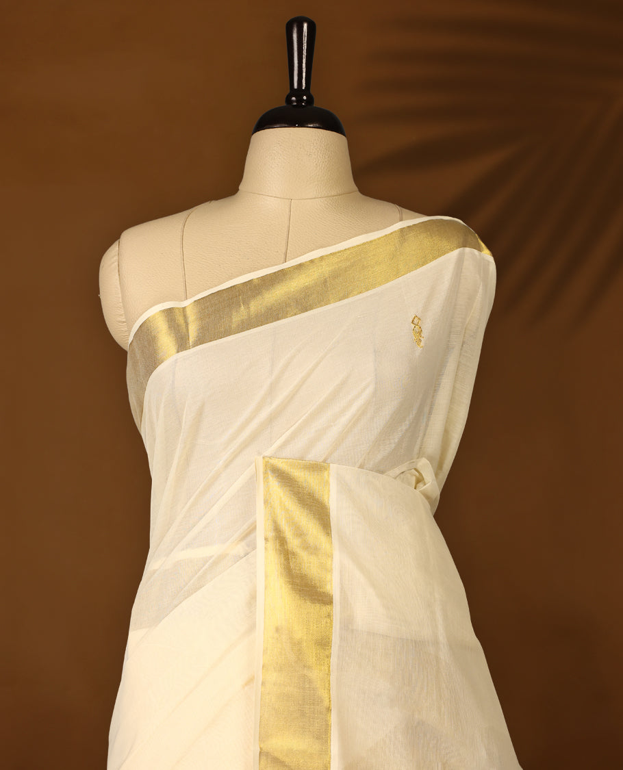 Elegant off white cotton Kerala saree with a plain body, gold zari fancy kasavu border, rich woven pallu, and matching blouse. Perfect for festive occasions and traditional celebrations.