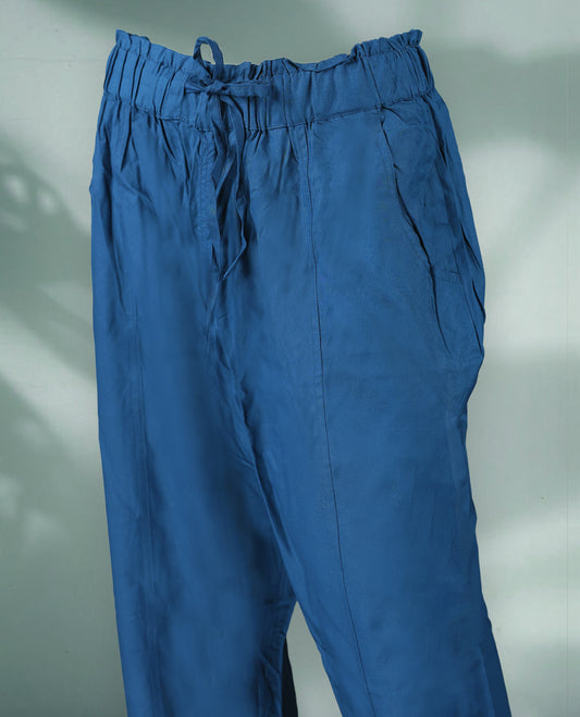 Blue colour women's pants feature a relaxed, ankle length design with an elasticated drawstring waistband and pleated detailing