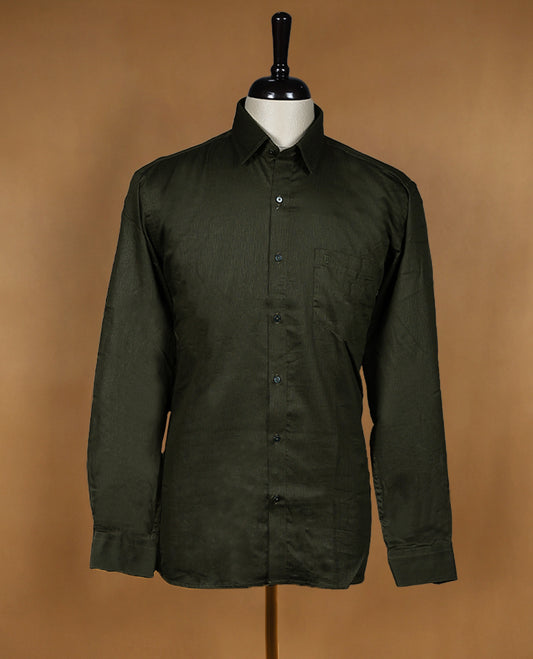 Deep olive green colour OTTO men's shirt in a relaxed formal fit, featuring a subtle self design pattern, classic collar, full sleeves, and a front chest pocket ideal for work or smart casual wear.
