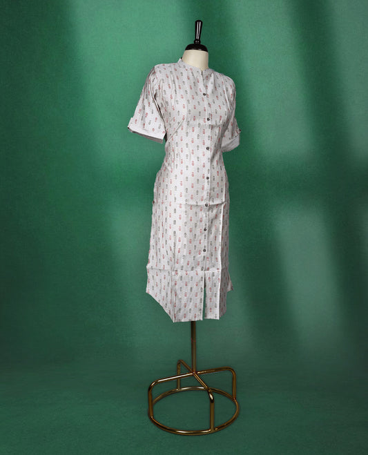 Beige colour cotton kurti with subtle red and grey all-over prints, featuring a mandarin collar, front button placket, and short roll up sleeves, comfortable and stylish choice for everyday wear