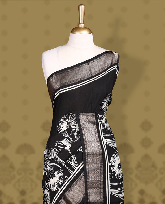 Black colour saree with off white floral and geometric prints, featuring a contrast zari border and beautifully detailed printed pallu & Comes with a matching black blouse piece.