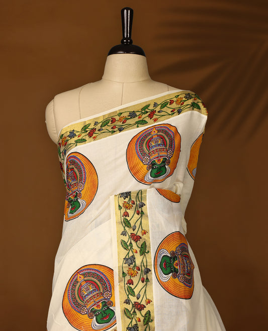Graceful off white colour cotton Kerala saree featuring vibrant Kathakali face motifs and a floral printed golden border. Traditional yet striking, perfect for festive and cultural celebrations.