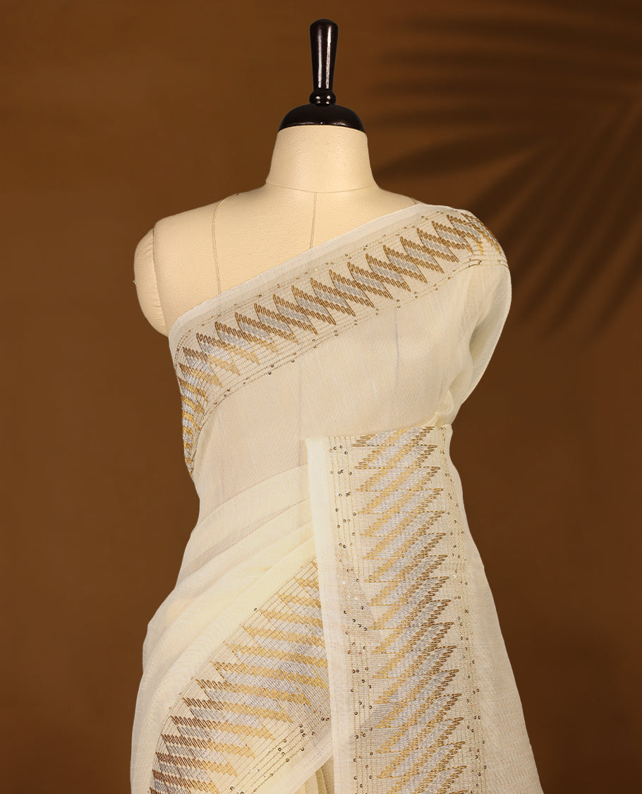 Ivory colour organza Kerala saree with golden zari detailing, featuring diagonal woven patterns on the pallu and border. Lightweight and elegant, it comes with a matching blouse piece for festive charm.