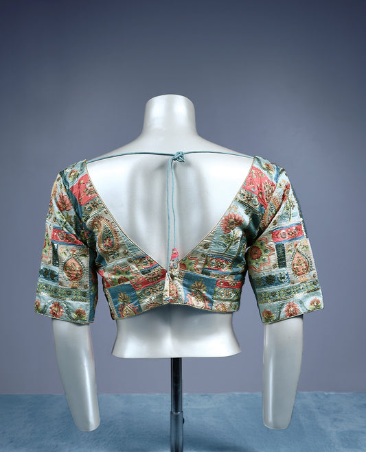 Multicolour V neck padded readymad blouse with elbow length sleeves, featuring an intricate patchwork style floral and paisley brocade pattern in shades of coral pink, teal blue, ivory, and gold.