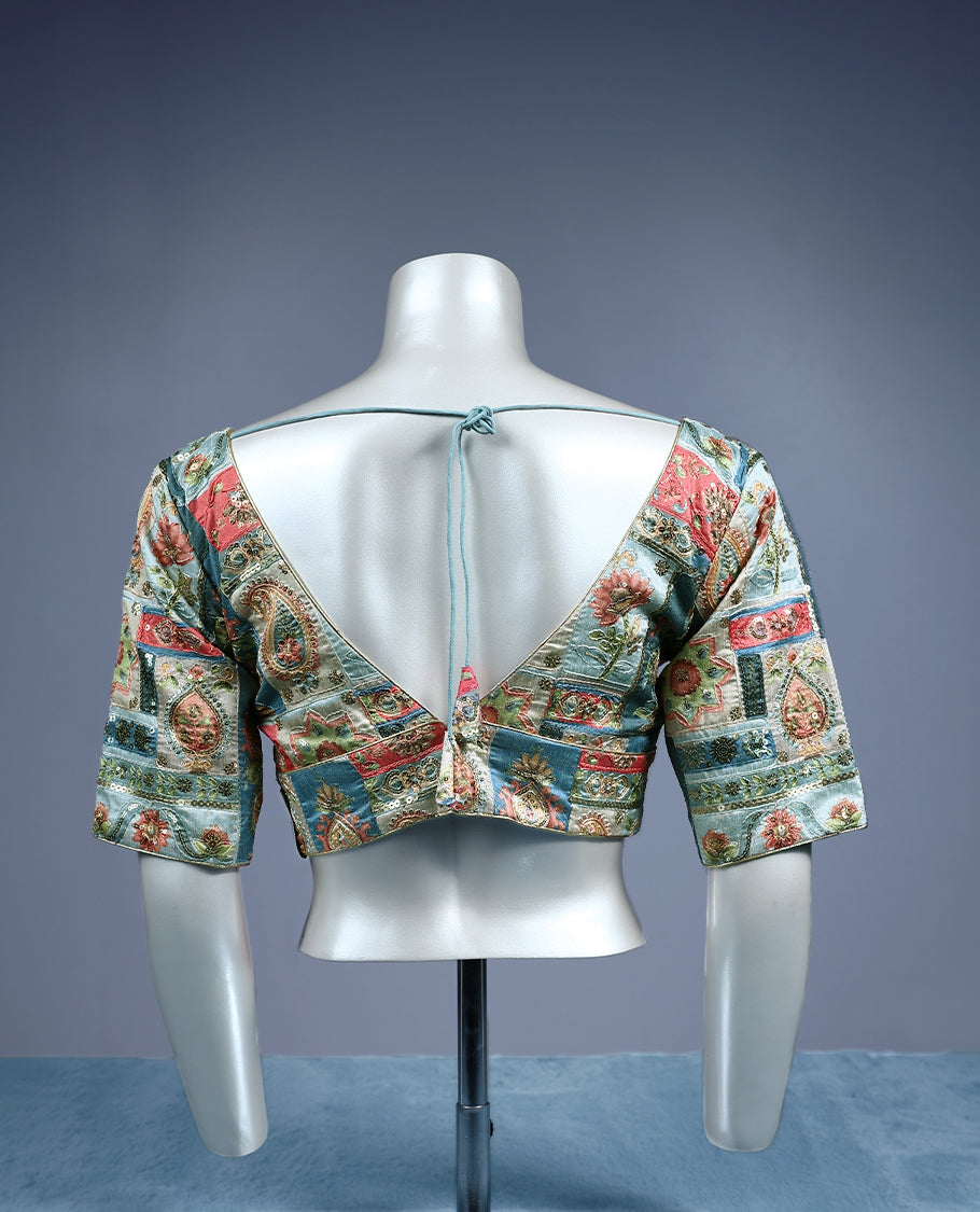 Multicolour V neck padded readymad blouse with elbow length sleeves, featuring an intricate patchwork style floral and paisley brocade pattern in shades of coral pink, teal blue, ivory, and gold.
