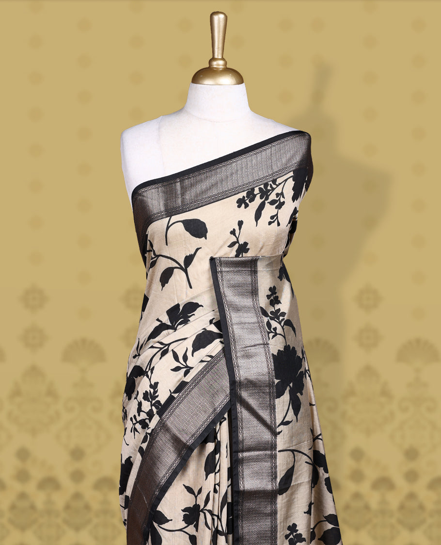 Beige colour saree adorned with bold black floral prints and a rich black zari border and stripped checkered pallu & Comes with a matching blouse piece.