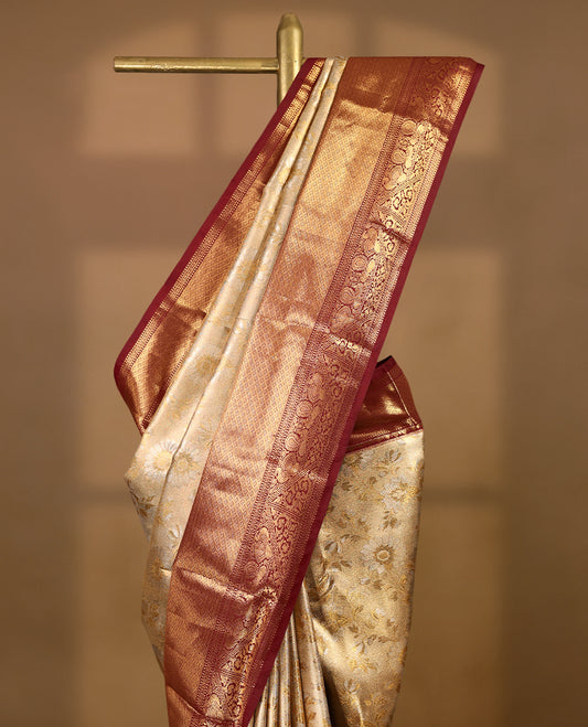Gold colour tissue brocade saree with gold and silver zari floral design on body, gold zari peacock & Flower traditional work Maroon border, rich matching pallu with Antique zari motifs, paired with matching blouse.