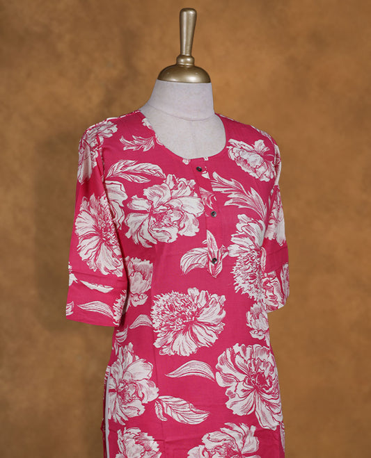 Pink colour coord set adorned with all over off white colour floral prints, featuring a straight cut kurta with round neckline and 3/4th sleeves, paired with matching bottoms.