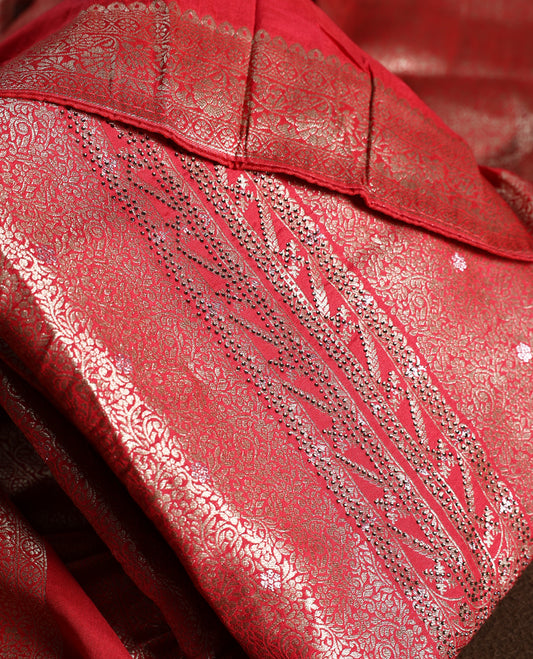 Maroon colour churidhar material with elegant golden zari floral weaves and stone embellishments, paired with a plain matching bottom and dupatta.