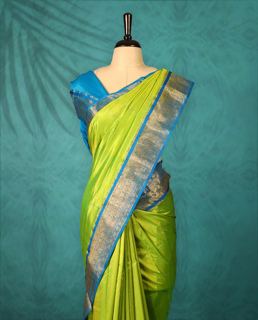 Neon Green colour Traditional Kancheepuram Silk saree with small gold motifs on body, Blue traditional border with intricate gold zari weaving, grand zari pallu, perfect for Bharatanatyam, with matching blouse.