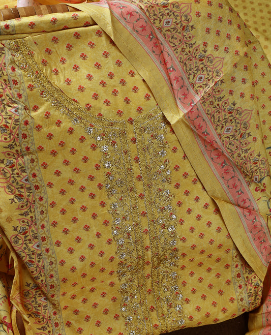 Yellow colour churidhar material with delicate floral embroidery on the neckline, complemented by a vibrant printed dupatta and plain bottom.