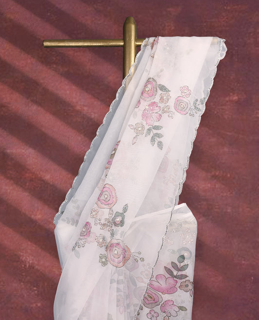 White colour pure organza saree featuring Multi Colour floral prints with intricate bead and sequin work across the body, adorned with a matching embellished border, complemented by a worked pallu and paired with a heavily worked matching blouse.