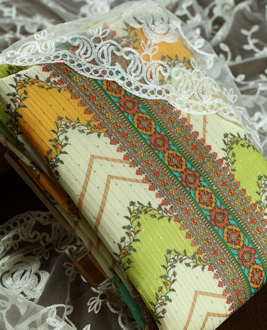 Cream colour churidhar material with embroidered neck work, floral motifs in yellow, green & orange shades, and patterned detailing on the body & Comes with matching plain bottom and embroidered net dupatta.