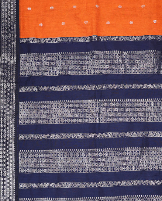 Deep Orange colour mixed Kalyani cotton saree featuring Silver zari flower motifs throughout the body, paired with Deep Navy Blue colour traditional border and pallu, with matching blouse