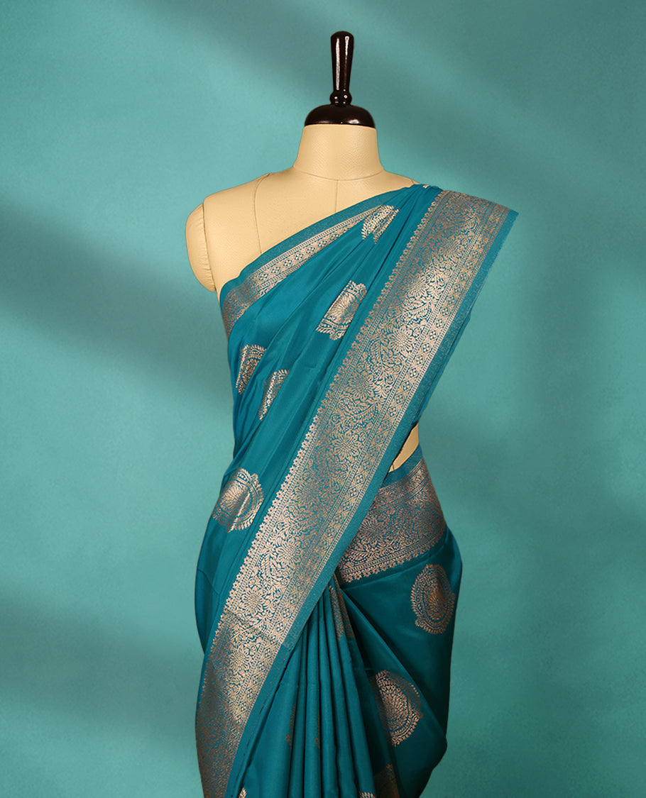 Blue coloured semi silk saree featuring a Golden Zari design on the body, paired with a Self coloured border and matching blouse.