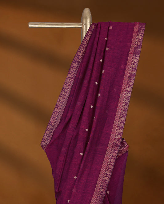 Deep Magenta colour soft khadi cotton saree with small Beige Zari Flower motifs on the body, detailed woven Gold zari border, paired pallu with tussles, with matching blouse.