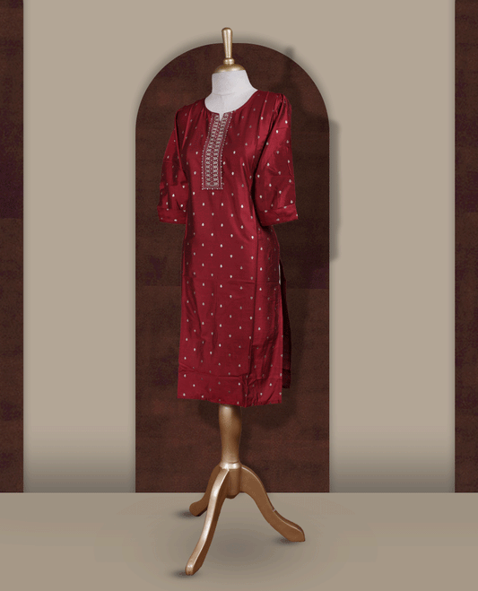 Deep maroon colour kurti from TWARA, adorned with subtle elegant motifs and intricate embroidery on the neckline, finished with a round neck and elbow length sleeves.