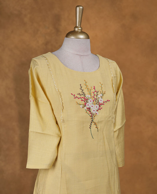 Yellow colour kurti with multicolour floral thread pattern, knee length design, styled with a round neckline and a  sleeve .
