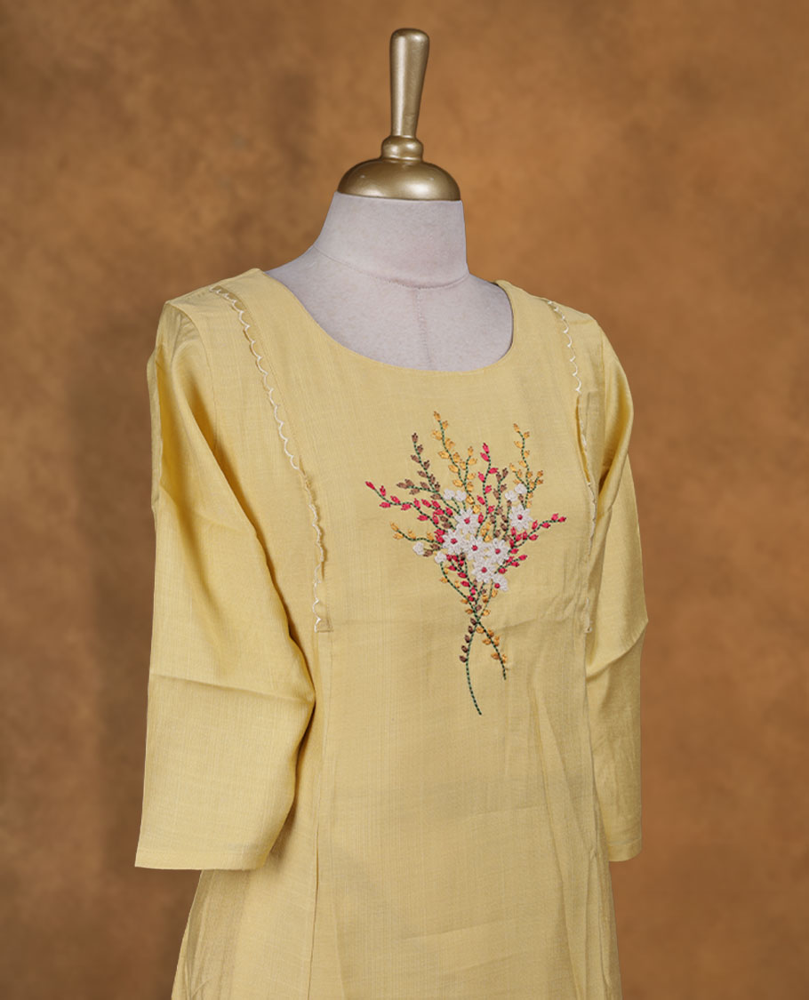 Yellow colour kurti with multicolour floral thread pattern, knee length design, styled with a round neckline and a  sleeve .