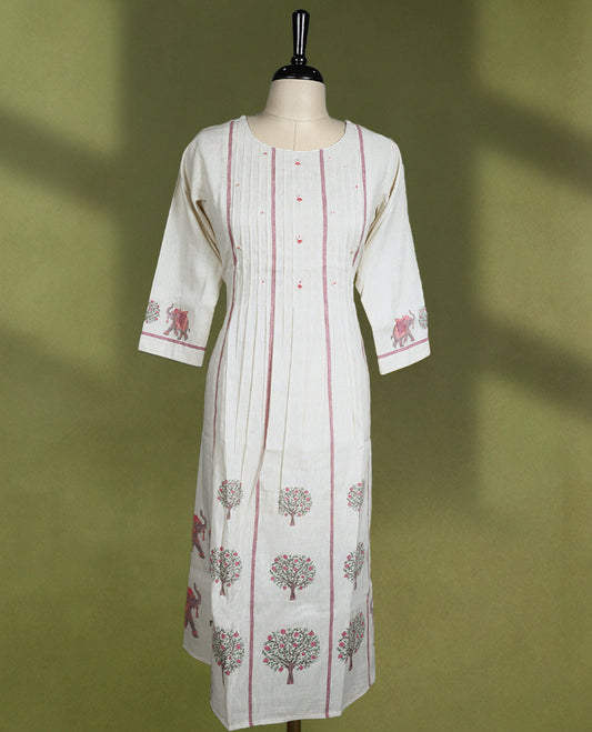 Cream coloured kurti featuring a round neck and three-quarter sleeves, adorned with vertical pintuck detailing and traditional tree and elephant prints