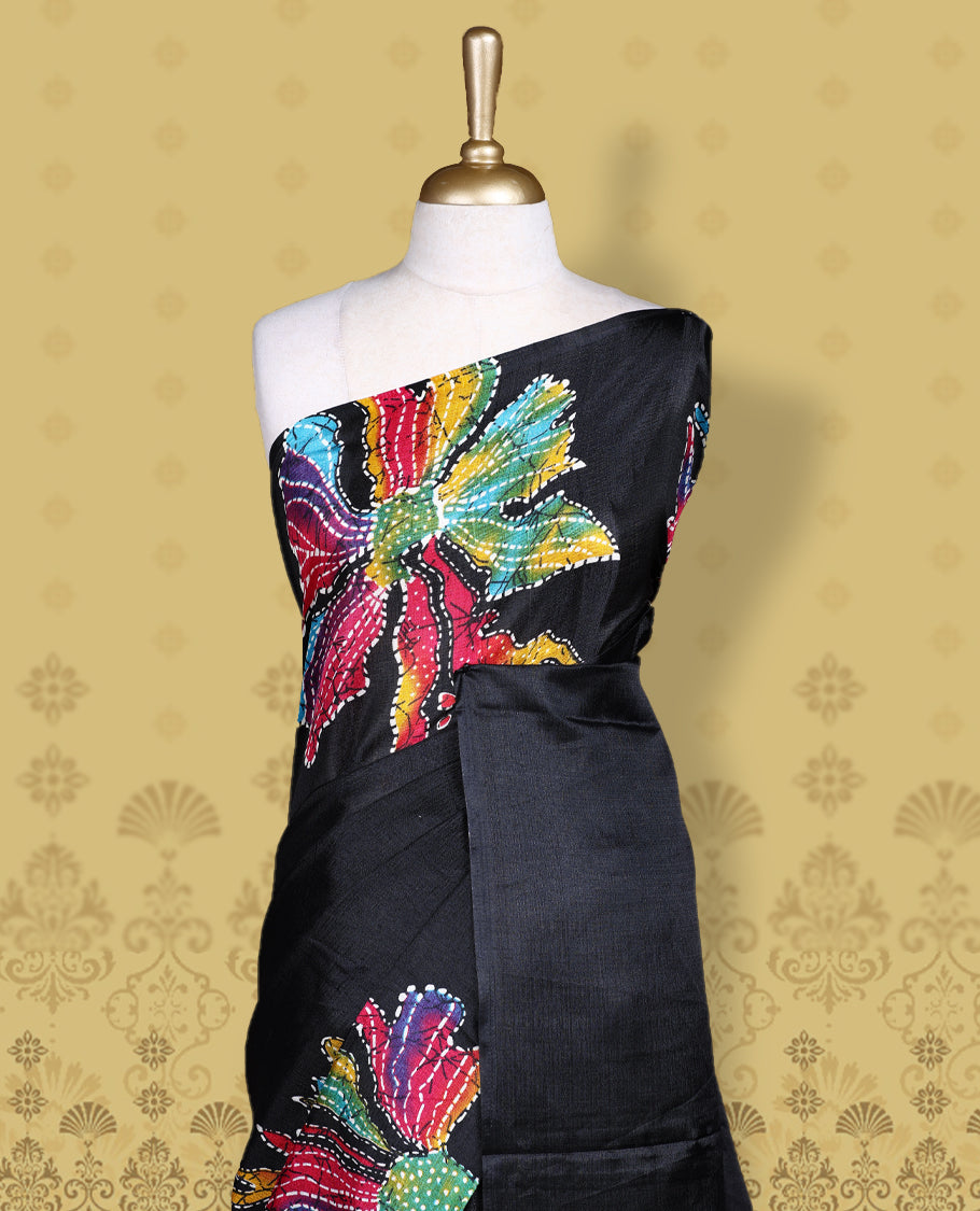 Black colour semi khadi silk saree adorned with yellow, green and magenta colour bold floral motifs across the body, designed without a border for a contemporary touch, and paired with a matching blouse.