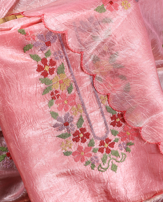 Baby pink colour churidhar material with elegant floral embroidery on the neckline and scalloped edges, paired with a plain matching bottom and a dupatta highlighted with floral motifs.
