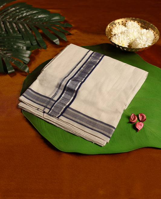 Off white colour pure handloom cotton double dhoti featuring a dark blue and silver kara with subtle textured detailing, designed for traditional grace, cultural elegance, and everyday comfort.