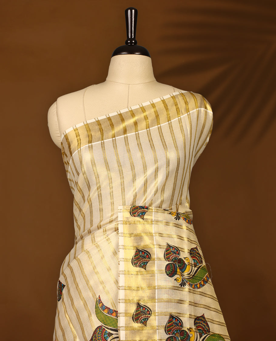 Elegant off white colour tissue Kerala saree featuring golden zari stripes, adorned with vibrant multicolour paisley motifs, and finished with a shimmering gold border and pallu & Paired with a matching blouse.