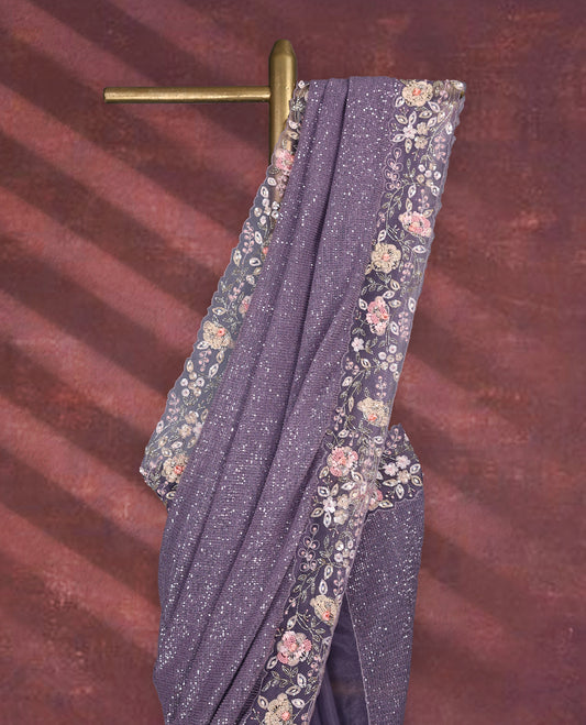 Pastel purple colour pure organza saree featuring all over sequin work, adorned with a matching floral kodi intricately worked border, complemented by a richly worked pallu and paired with a heavily embellished matching blouse.