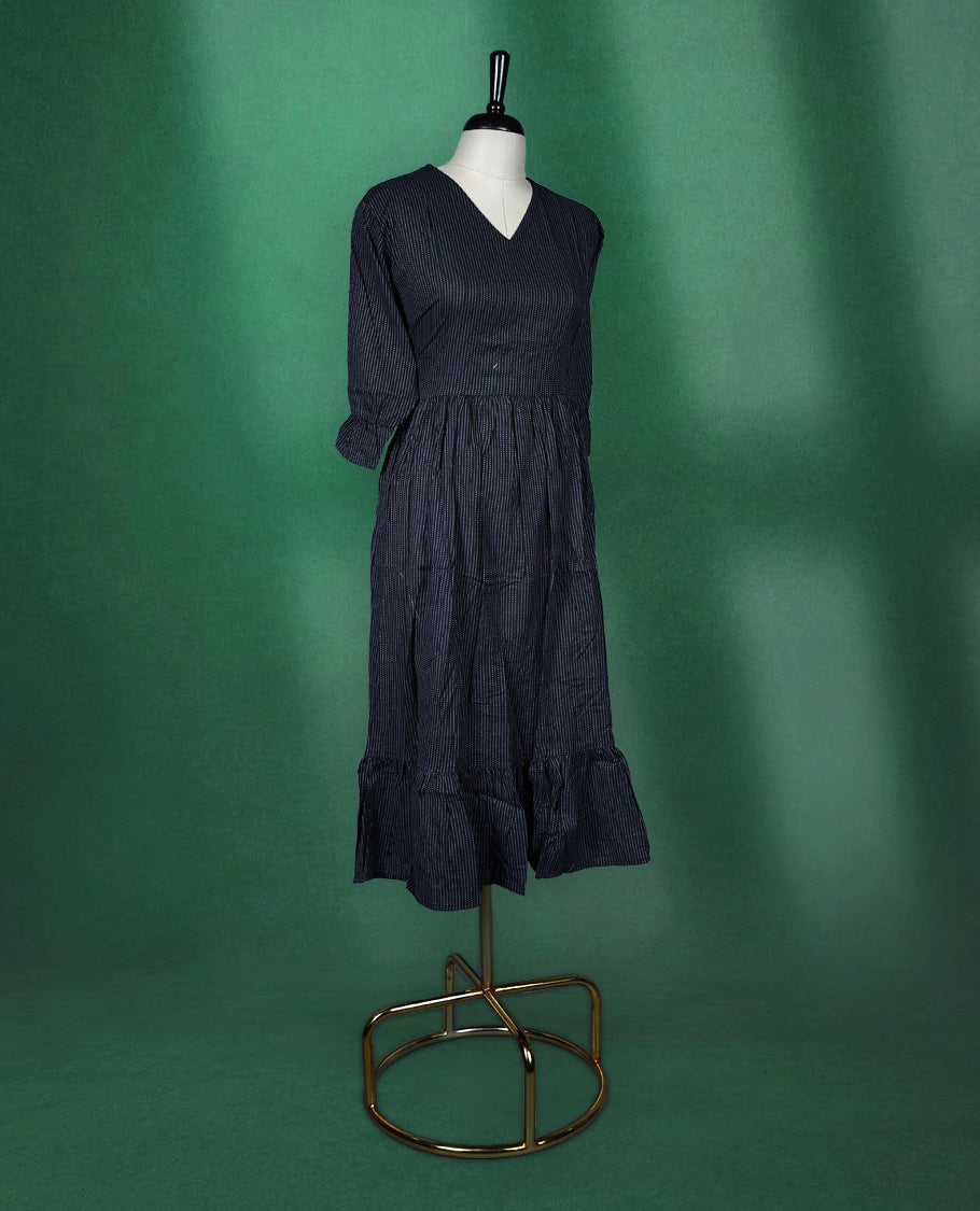 Black colour dress featuring subtle pinstripes, a V neckline, and three quarter sleeves, finished with a gathered waist and ruffled hem, chic and comfortable choice for casual outings.