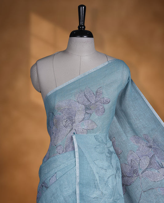 Ice blue colour pure linen saree featuring Floral print pattern across body, silver thin border finished with matching blouse.