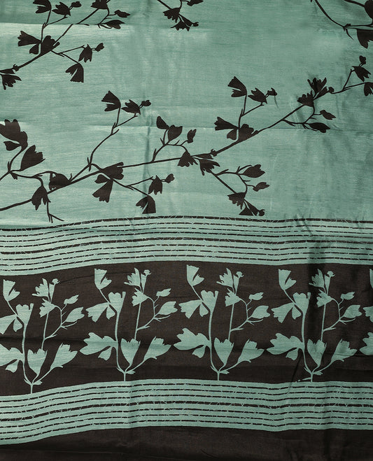 Pastel aqua colour semi printed saree featuring black florak kodi prints across the body, finished with a sleek plain border, with matching blouse