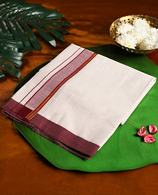 Off white cotton single dhoti featuring a maroon kara highlighted with golden zari edging and fine double lines, blending tradition with elegance, perfect for rituals, festive occasions, and cultural gatherings.